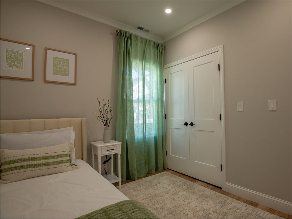 93 Grove Street, Unit 1R Fall River, MA 02720 - Photo 14 of 21 a bedroom with a bed and a view of bathroom