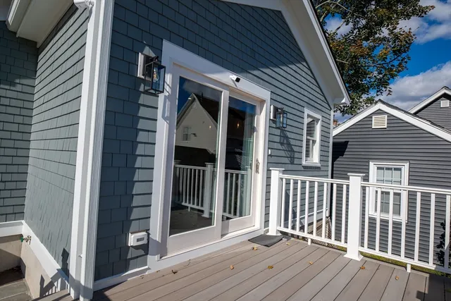 a view of a house and wooden deck