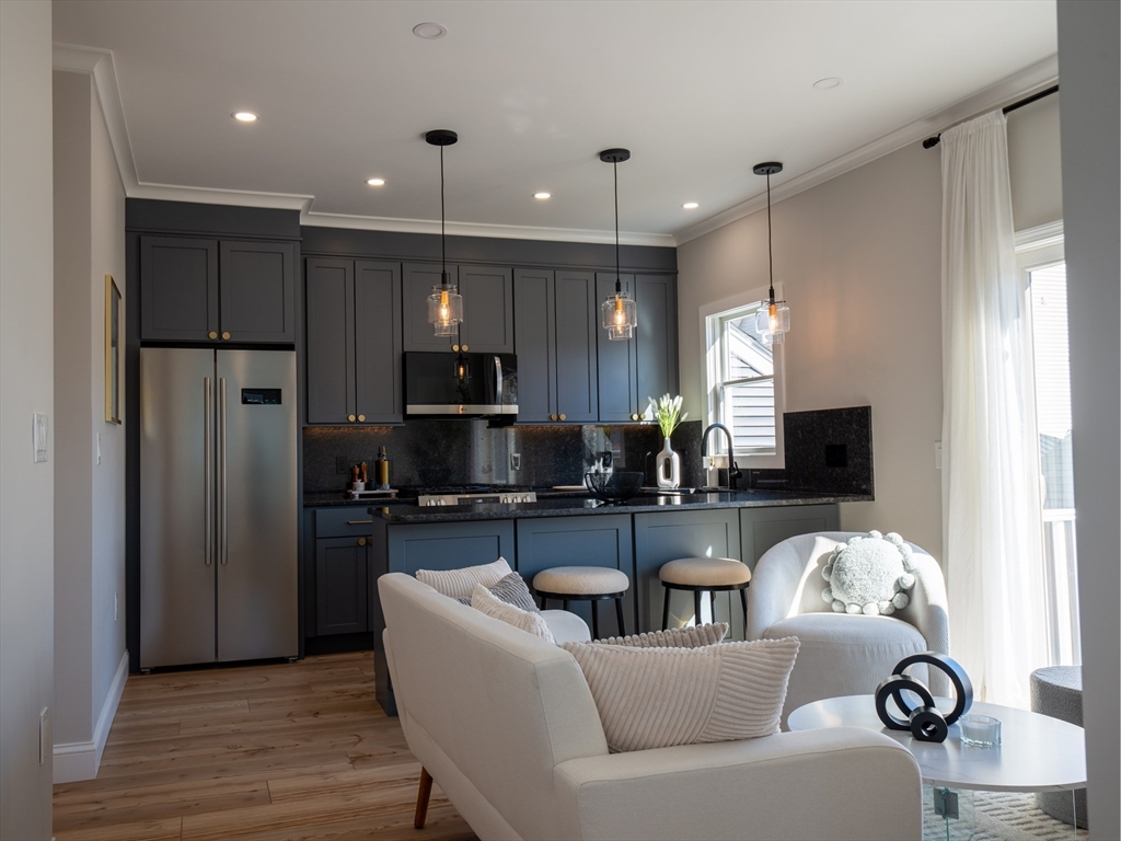 93 Grove Street, Unit 1R Fall River, MA 02720 - Photo 4 of 21 a living room with stainless steel appliances kitchen island granite countertop furniture a refrigerator a sink a stove and a microwave