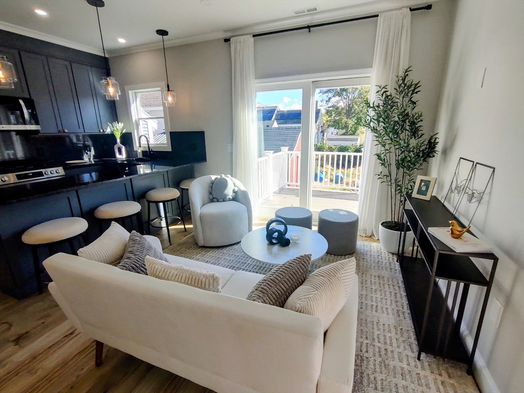 93 Grove Street, Unit 1R Fall River, MA 02720 - Photo 7 of 21 a living room with furniture and a large window