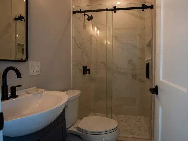 a bathroom with a sink toilet and shower