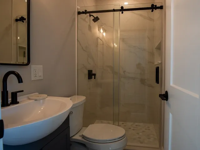 a bathroom with a sink toilet and shower