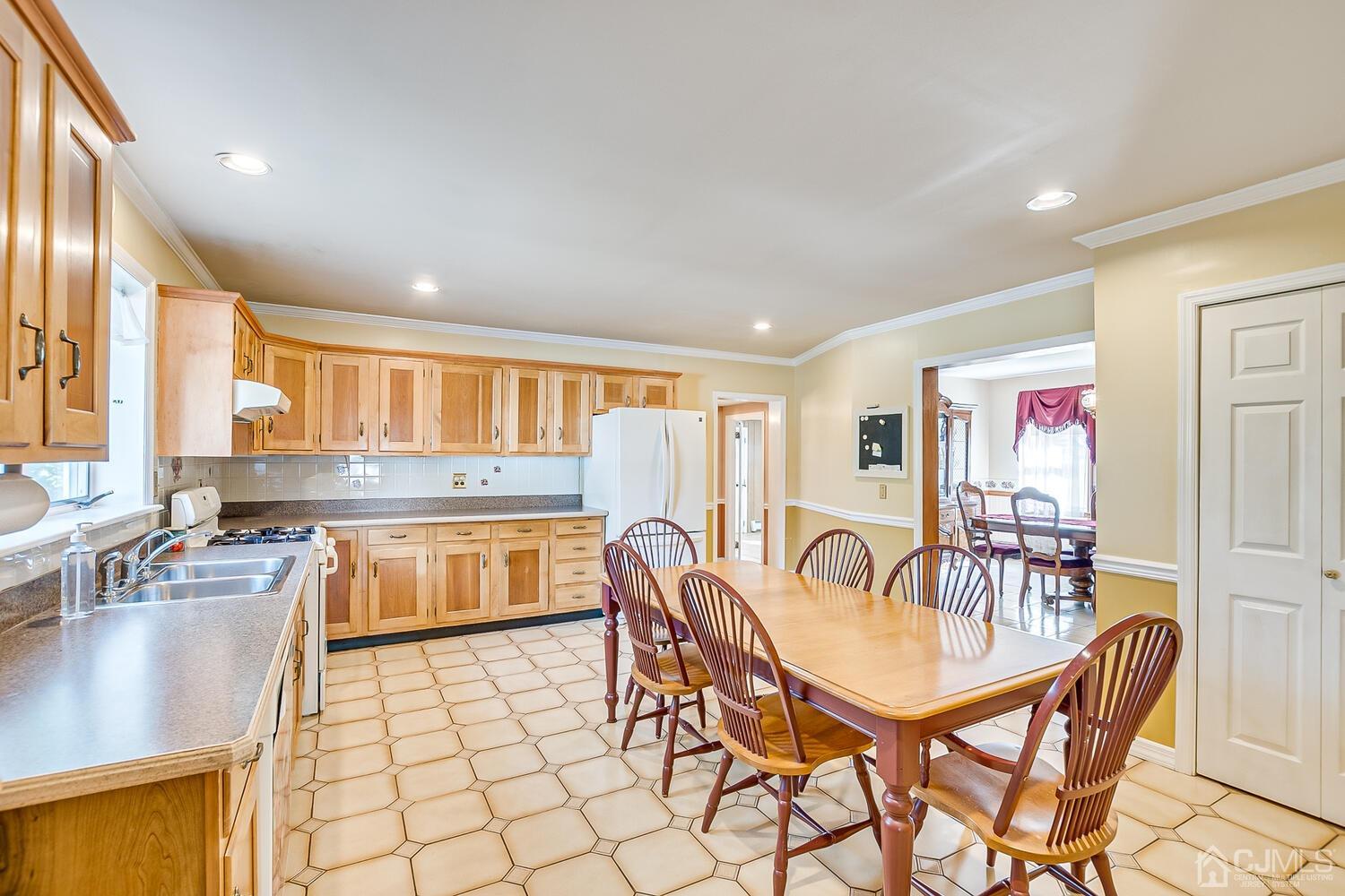 7 Paley Place Edison, NJ 08817 - Photo 14 of 53 a kitchen with stainless steel appliances granite countertop a stove a sink a dining table and chairs