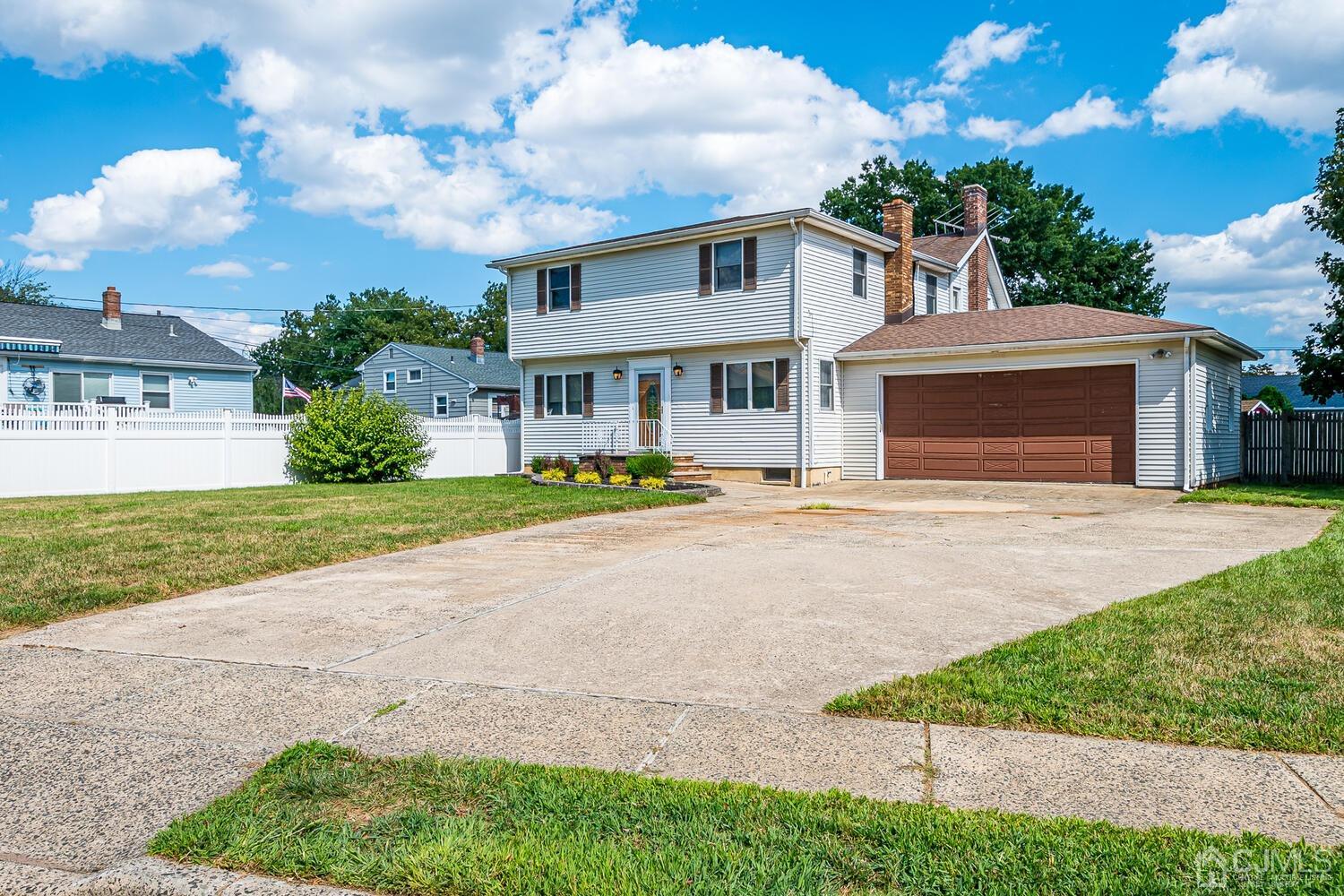 7 Paley Place Edison, NJ 08817 - Photo 2 of 53 a front view of a house with a yard and potted plants
