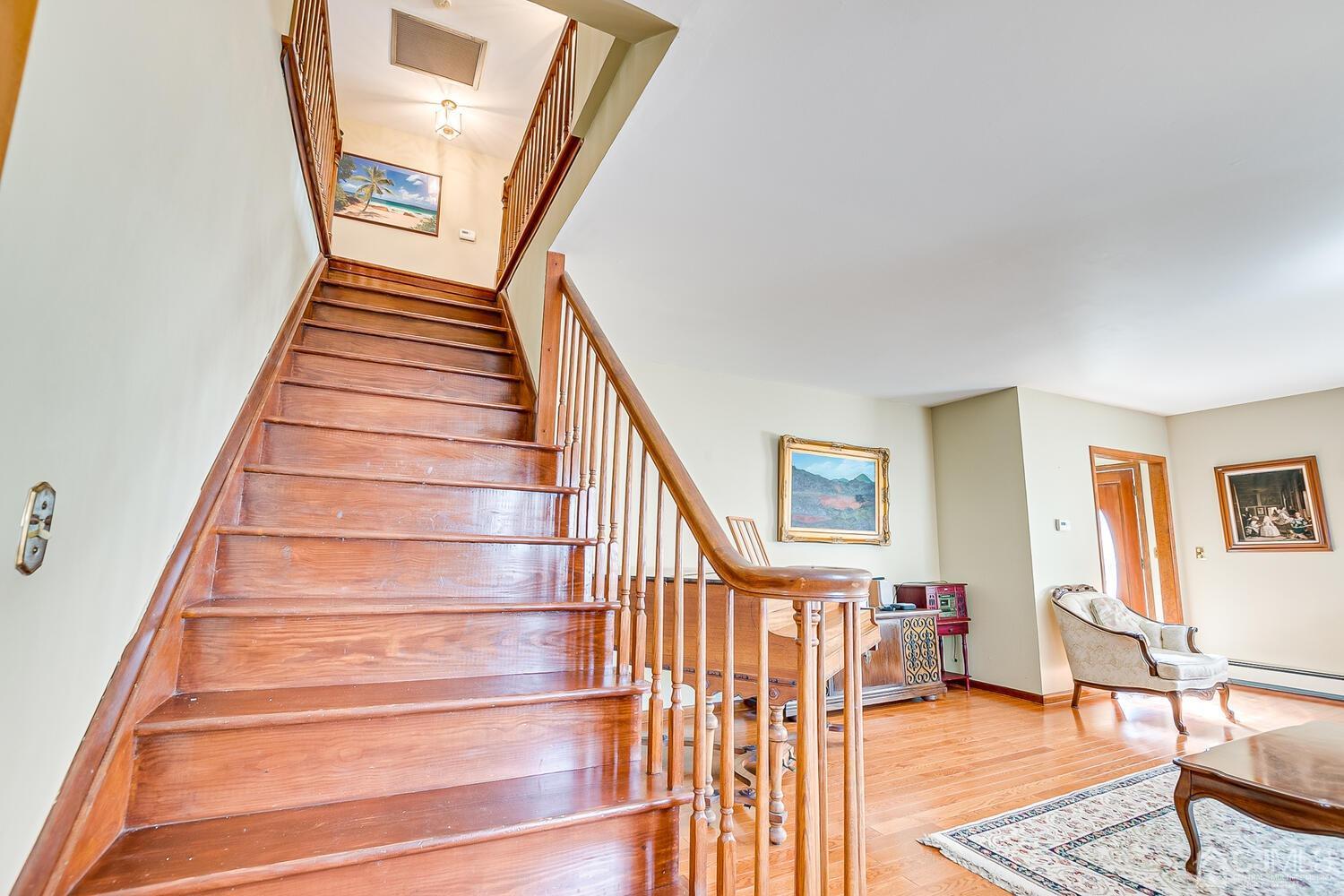 7 Paley Place Edison, NJ 08817 - Photo 23 of 53 a view of staircase with lots of frames on wall and a window