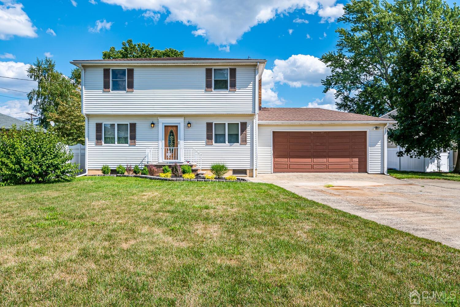 7 Paley Place Edison, NJ 08817 - Photo 3 of 53 a front view of a house with a yard and garage