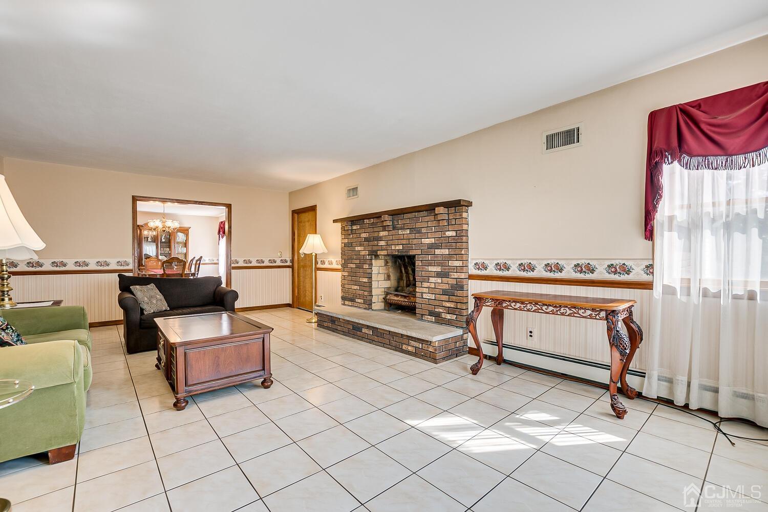 7 Paley Place Edison, NJ 08817 - Photo 5 of 53 a living room with furniture a fireplace and a flat screen tv