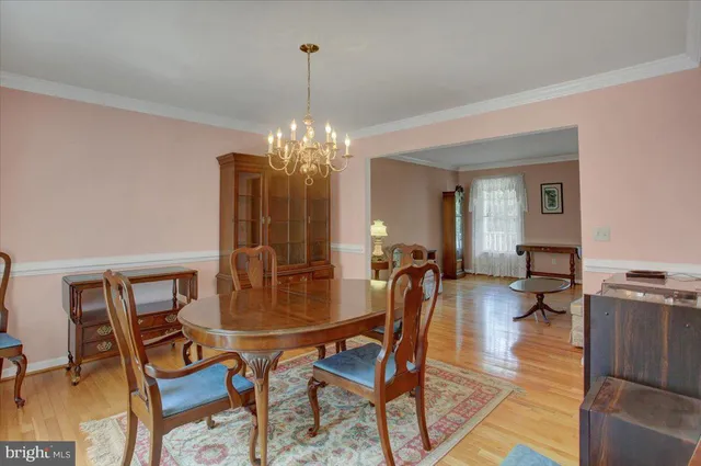 a view of a dining room with furniture and chandelier
