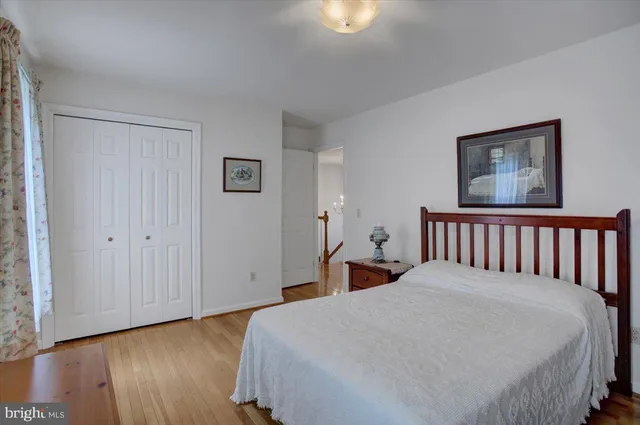 a bed room with a bed and a painting on the wall