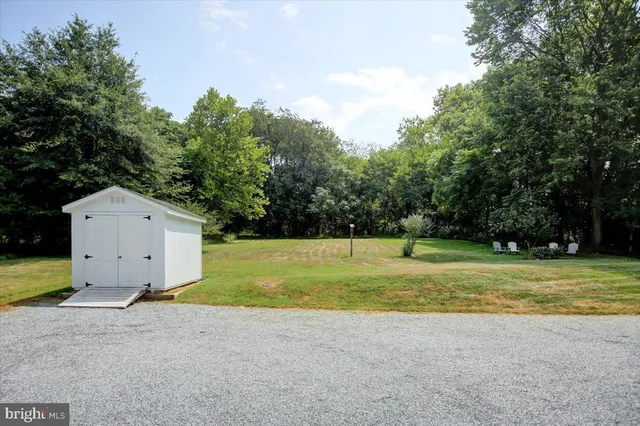 a view of a house with pool and a yard