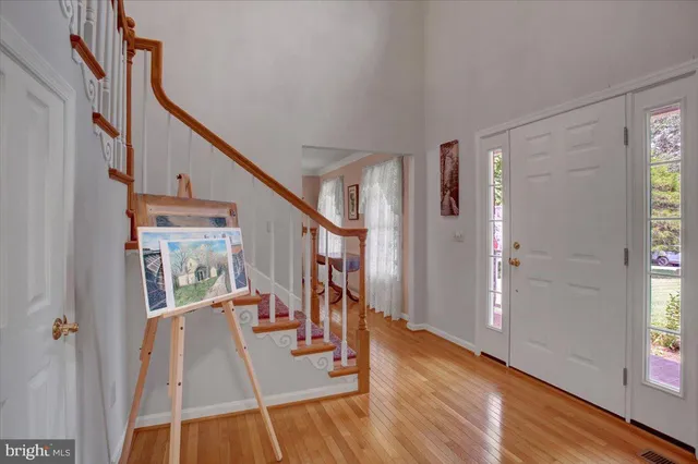 a view of entryway with wooden floor and stairs