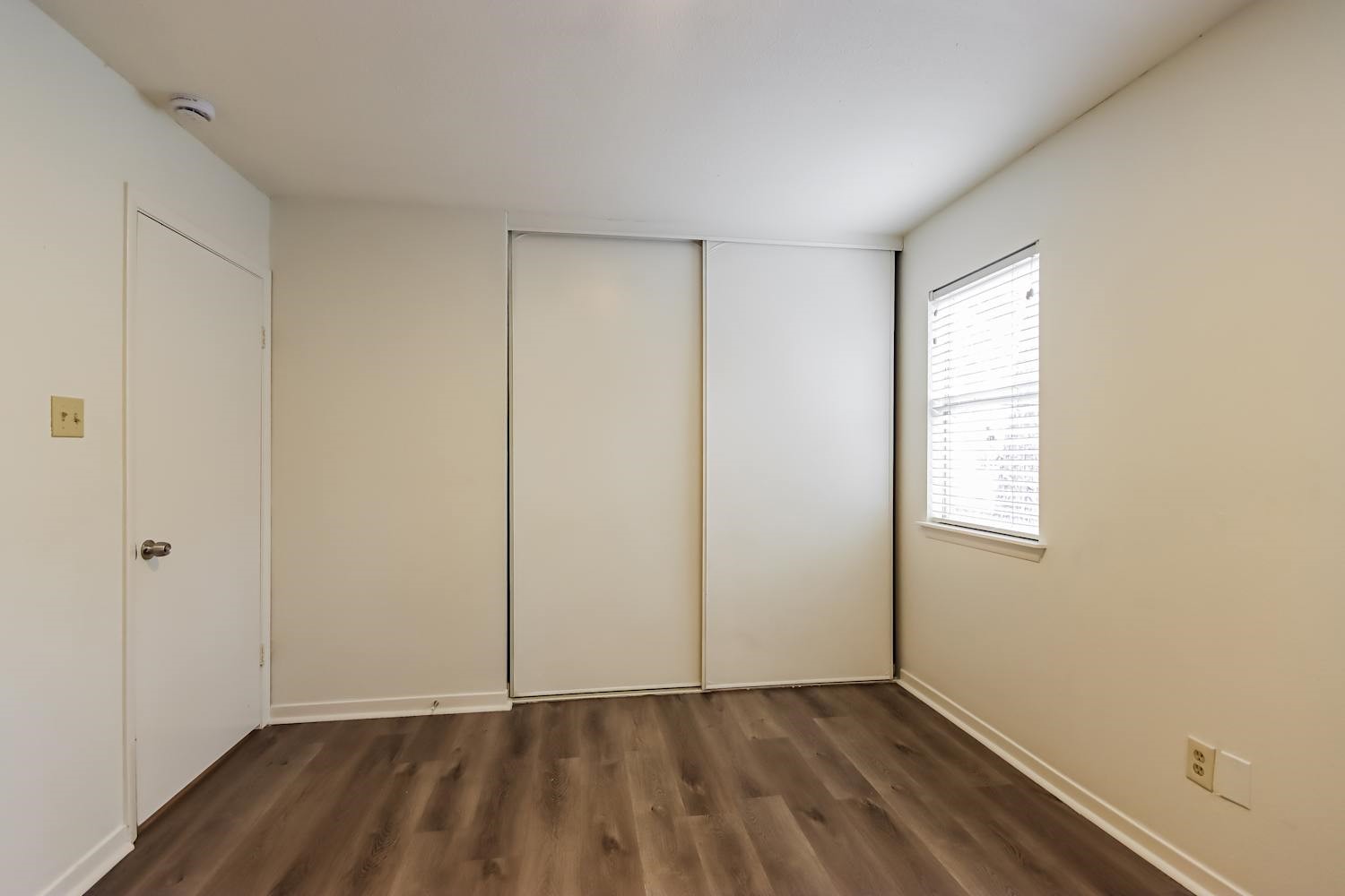 10 Shallow Pond Place Spring, TX 77381 - Photo 14 of 17 an empty room with wooden floor and windows