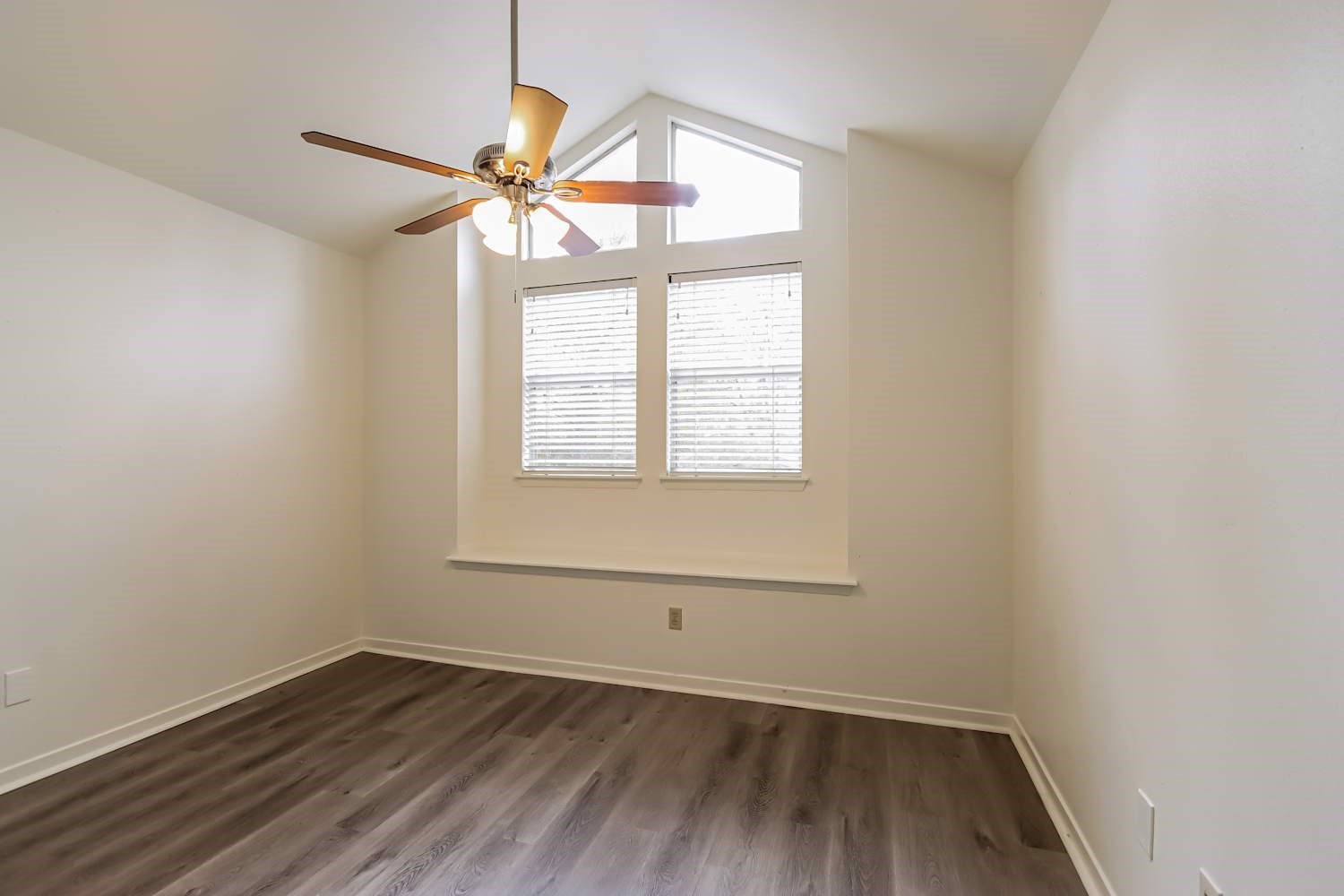 10 Shallow Pond Place Spring, TX 77381 - Photo 15 of 17 an empty room with wooden floor fan and windows
