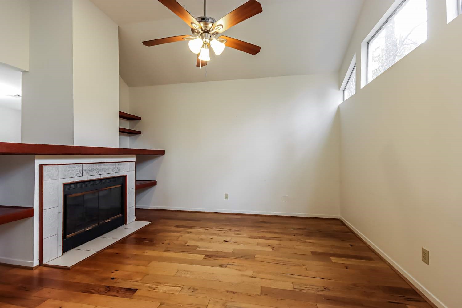 10 Shallow Pond Place Spring, TX 77381 - Photo 6 of 17 an empty room with windows a fireplace