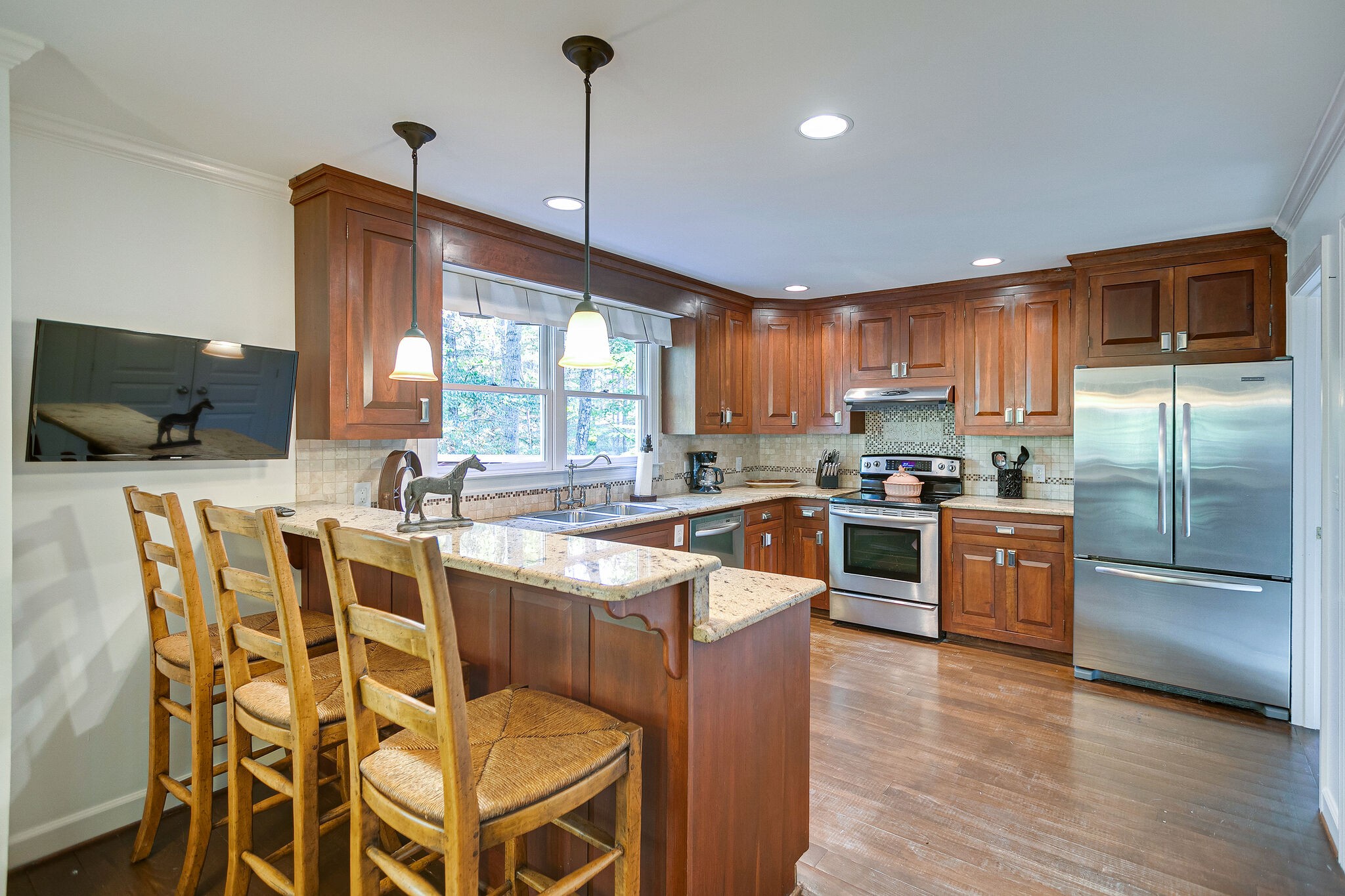 5629 Pinewood Road Franklin, TN 37064 - Photo 14 of 49 a kitchen with stainless steel appliances granite countertop a stove a sink a microwave a center island and a refrigerator