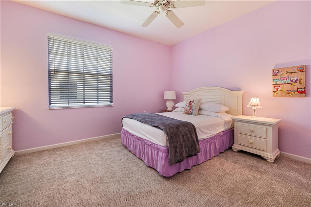 19081 Ridgepoint Drive, Unit 201 Estero, FL 33928 - Photo 20 of 42 a bedroom with a bed and a chandelier