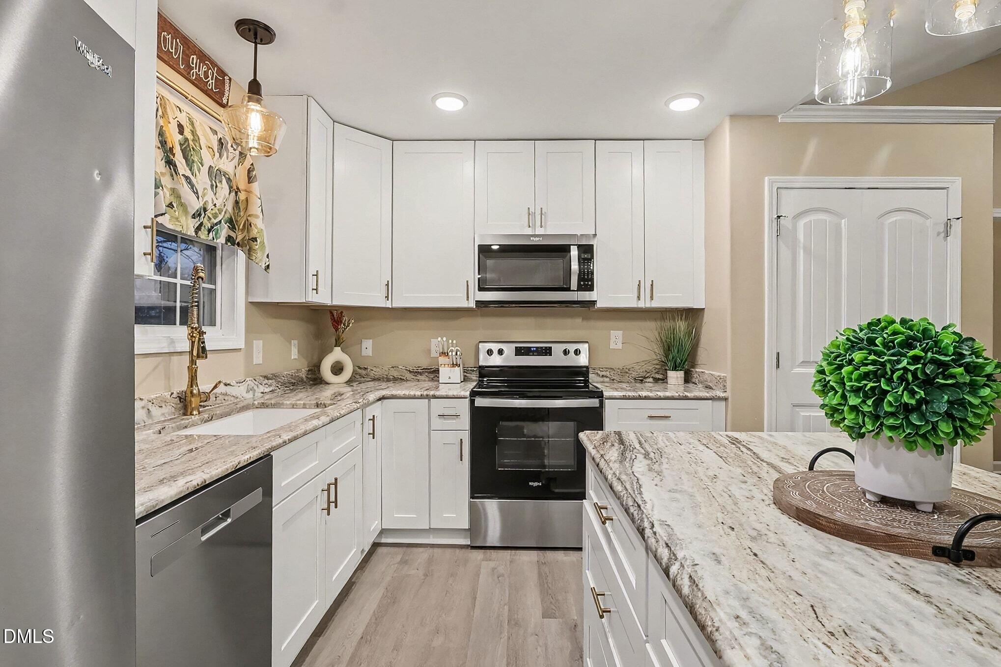 115 Southern High School Road Graham, NC 27253 - Photo 15 of 34 a kitchen with a sink stove and cabinets