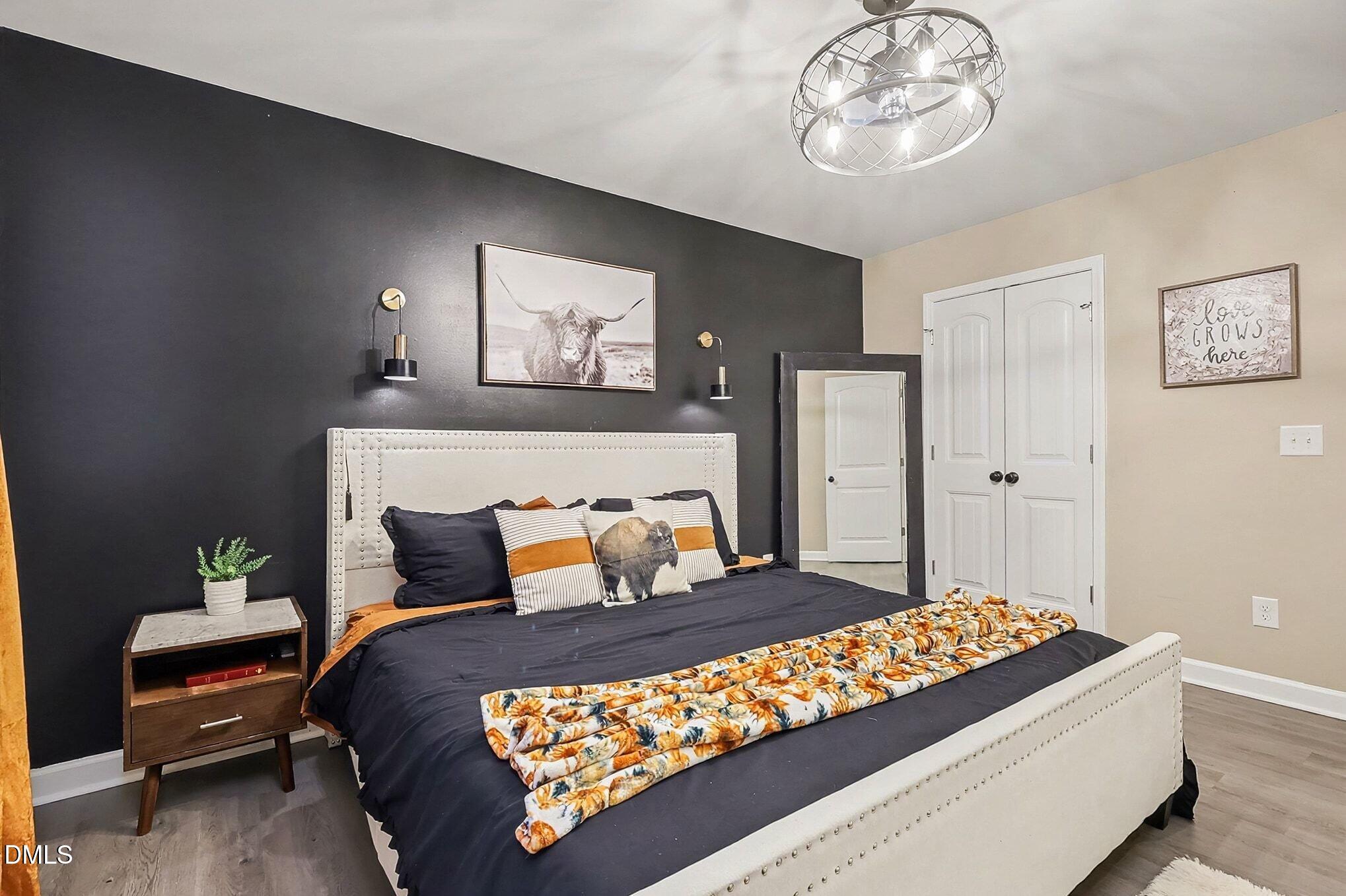 115 Southern High School Road Graham, NC 27253 - Photo 17 of 34 a bedroom with a bed and a chandelier