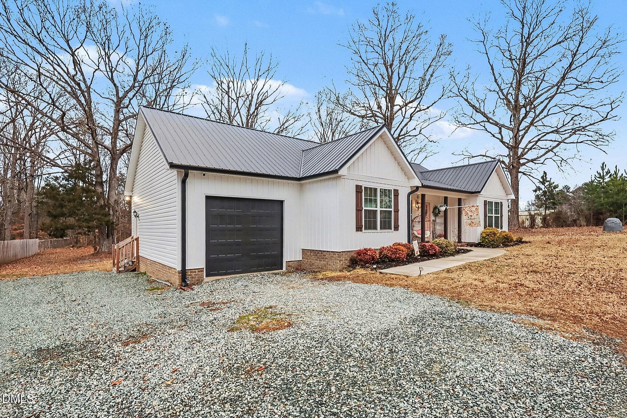 115 Southern High School Road Graham, NC 27253 - Photo 5 of 34 a view of a house with a yard covered in snow
