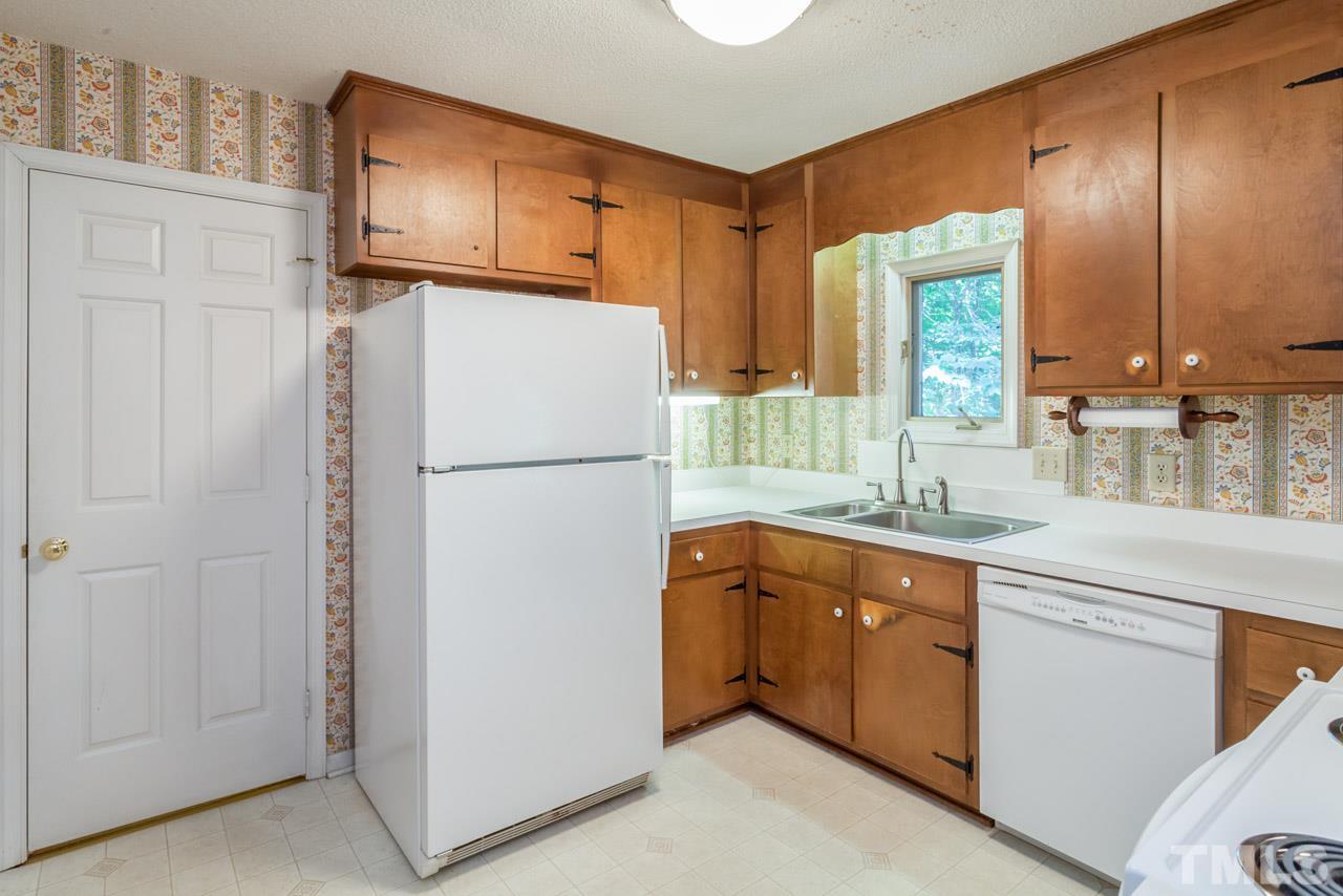 3000 Sylvania Drive Raleigh, NC 27607 - Photo 15 of 25 a kitchen with stainless steel appliances granite countertop a refrigerator a sink and white cabinets