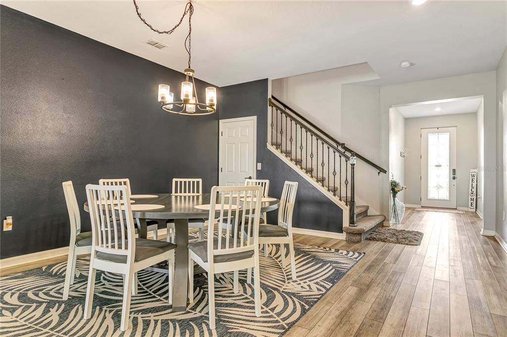 11701 Brighton Knoll Loop Riverview, FL 33579 - Photo 11 of 70 a view of a dining room with furniture wooden floor and chandelier