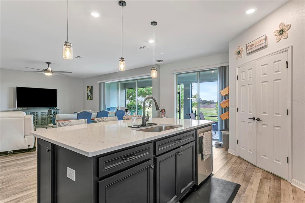 11701 Brighton Knoll Loop Riverview, FL 33579 - Photo 17 of 70 a kitchen with a sink a counter top space and a center island