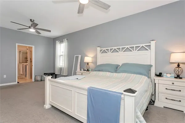 a view of a hallway with wooden floor and closet area