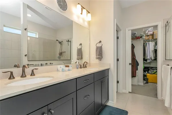 a bedroom with a bed and a white cabinet