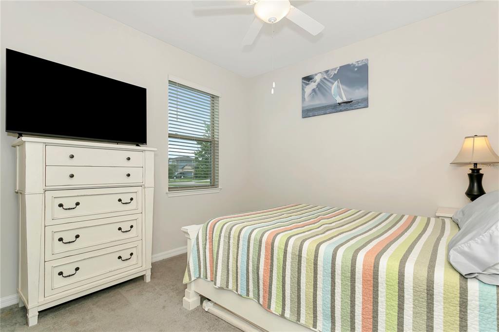 11701 Brighton Knoll Loop Riverview, FL 33579 - Photo 29 of 70 a bedroom with a bed and a flat screen tv
