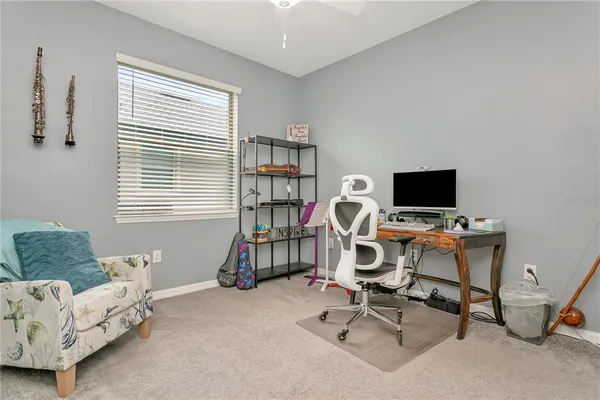 a living room with furniture ceiling fan and a window
