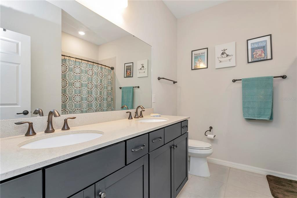 11701 Brighton Knoll Loop Riverview, FL 33579 - Photo 36 of 70 a bathroom with a toilet sink double vanity and mirror