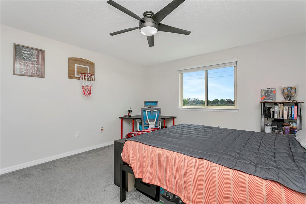 11701 Brighton Knoll Loop Riverview, FL 33579 - Photo 38 of 70 a bedroom with a bed a table and chair
