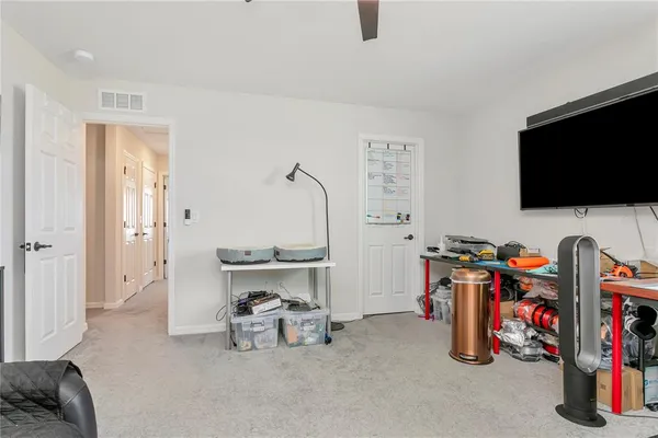 a living room with furniture and a floor to ceiling window