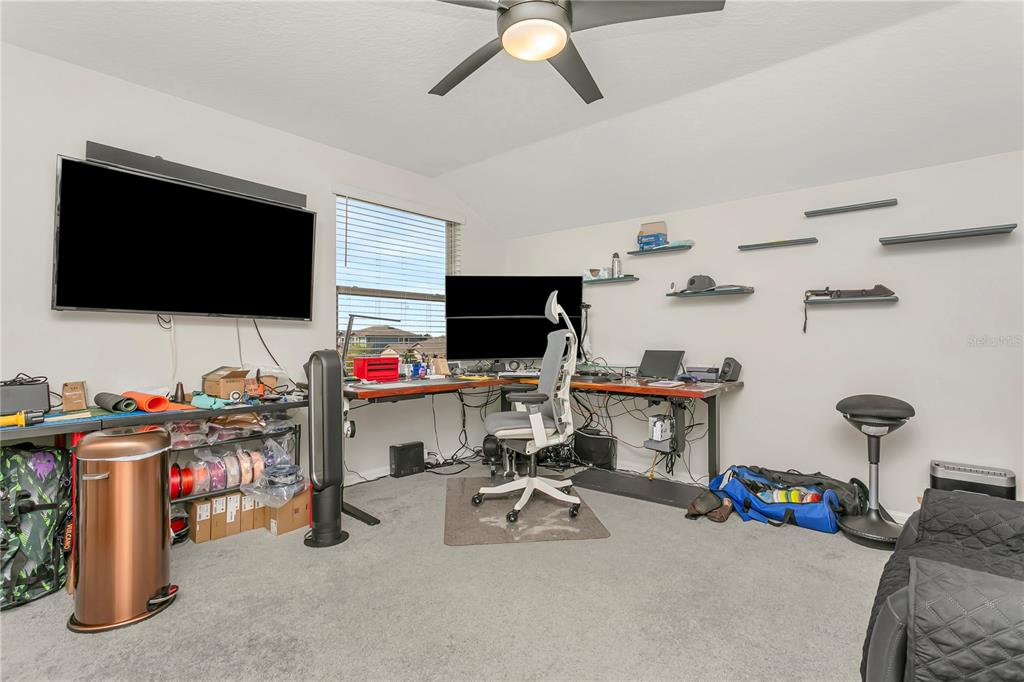 11701 Brighton Knoll Loop Riverview, FL 33579 - Photo 41 of 70 a view of a workspace with furniture and a flat screen tv