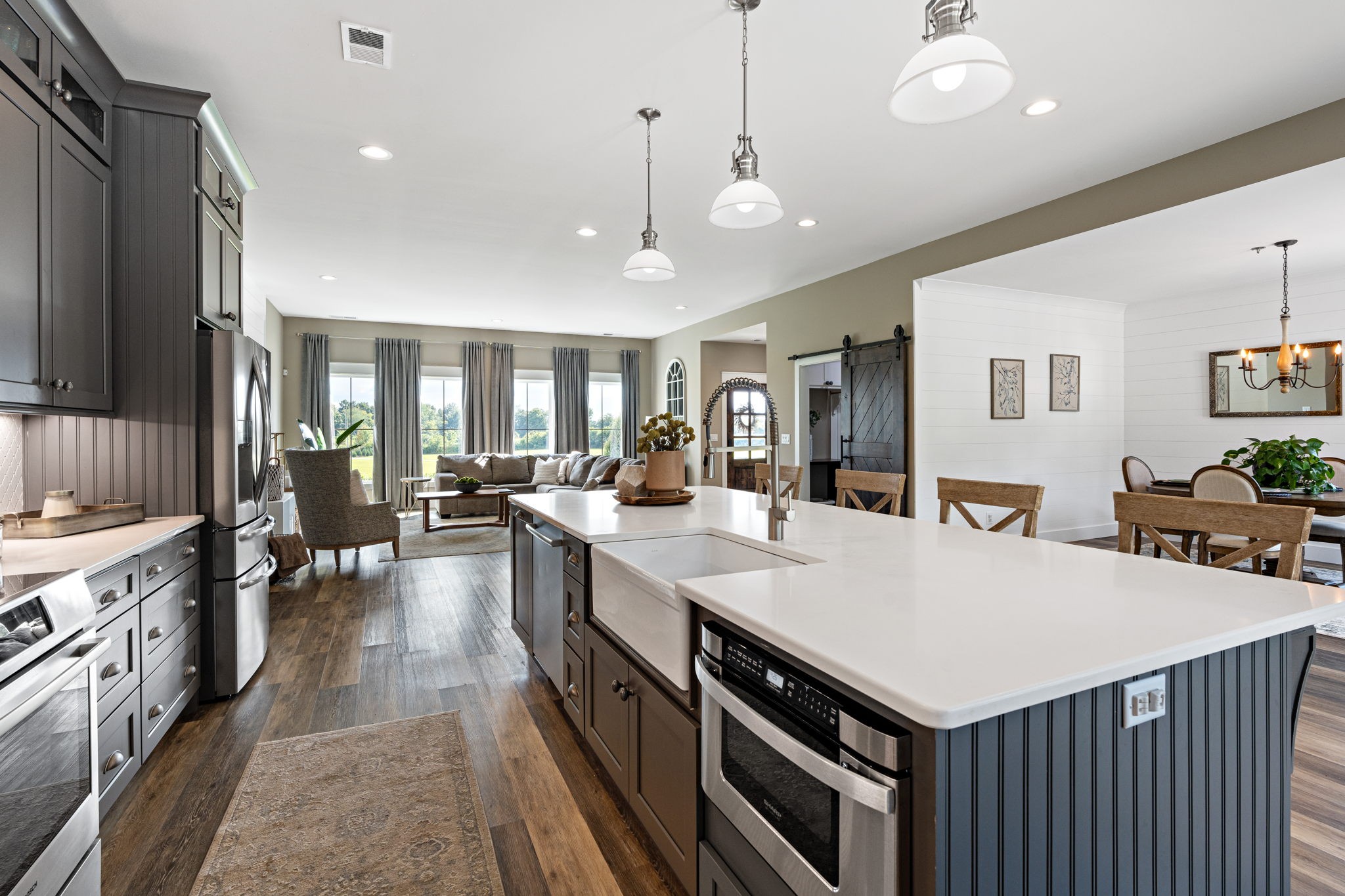 8518 Newtown Road Rockvale, TN 37153 - Photo 10 of 69 a large kitchen with kitchen island a stove a sink a dining table and chairs