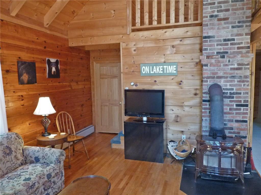 75 Brooks And Dunn Road Otis, ME 04605 - Photo 14 of 35 Living room with heat stove.