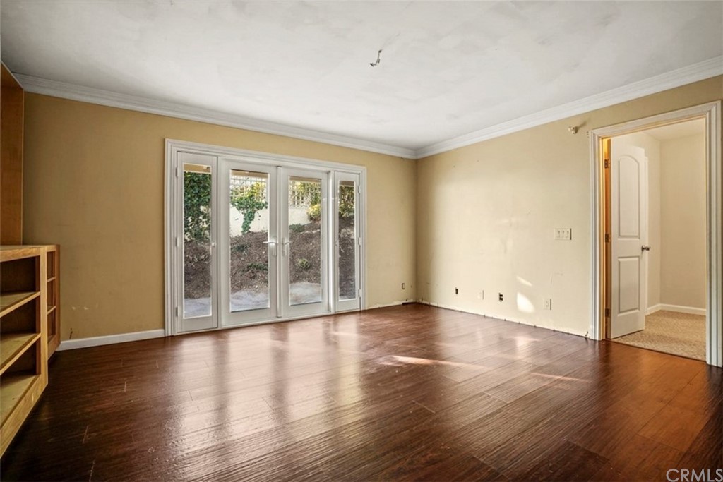 595 Windsor Place Laguna Beach, CA 92651 - Photo 12 of 26 a view of an empty room with wooden floor and a window