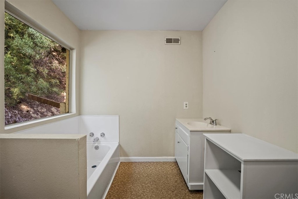 595 Windsor Place Laguna Beach, CA 92651 - Photo 13 of 26 a utility room with a sink a washer and dryer