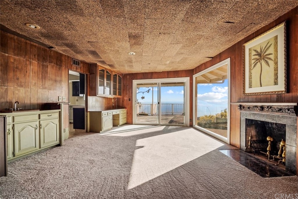 595 Windsor Place Laguna Beach, CA 92651 - Photo 8 of 26 a view of living room kitchen with stainless steel appliances granite countertop cabinets and fireplace