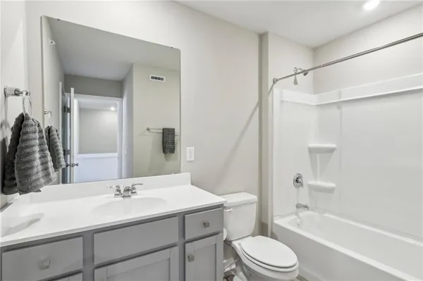 a bathroom with a sink toilet tub and shower