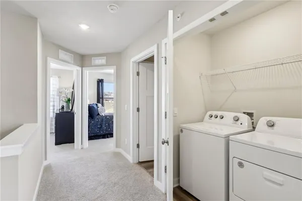 a view of storage and utility room with washer and dryer