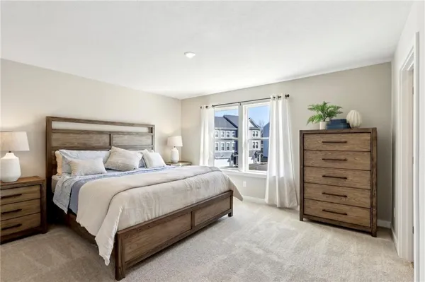 a bedroom with a bed and a dresser