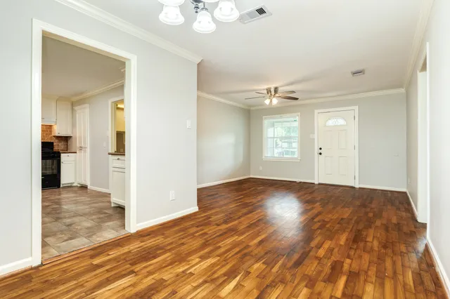 wooden floor in an empty room with a window