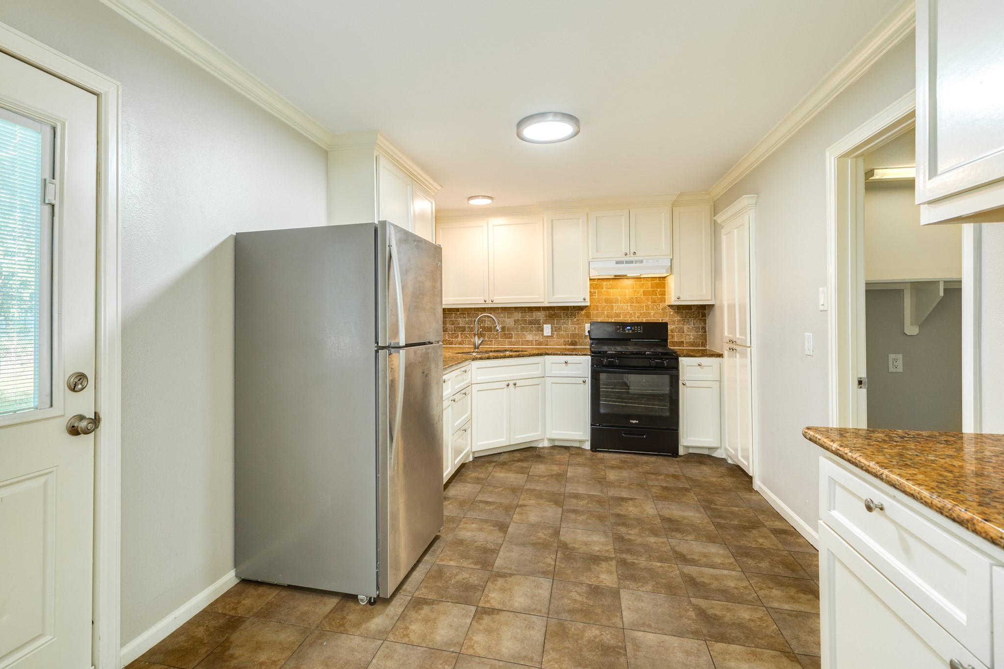 840 South Morgan Street Angleton, TX 77515 - Photo 14 of 28 a kitchen with a refrigerator and a stove