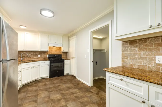 a kitchen with a refrigerator stove and sink