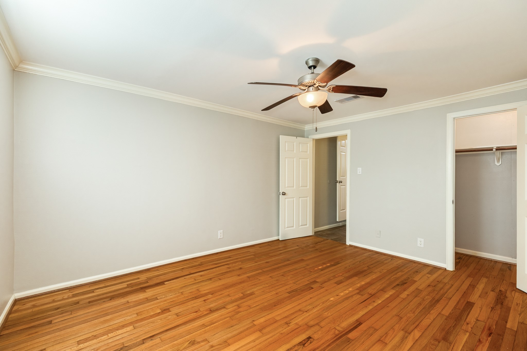 840 South Morgan Street Angleton, TX 77515 - Photo 20 of 28 a view of a big room with wooden floor and a ceiling fan