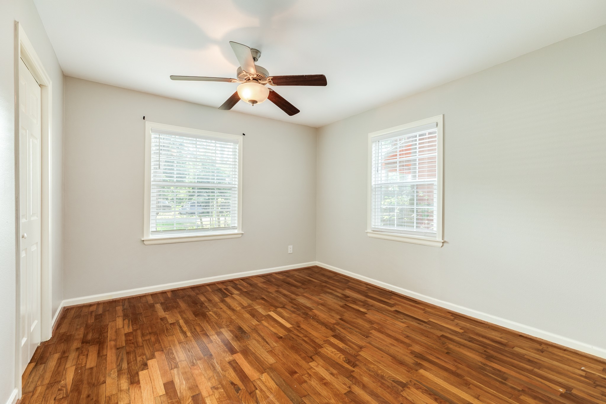 840 South Morgan Street Angleton, TX 77515 - Photo 22 of 28 a view of empty room with wooden floor and fan