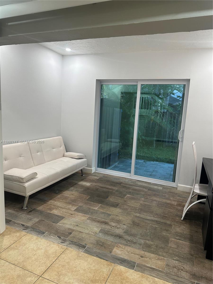 9724 Southwest 142nd Place Miami, FL 33186 - Photo 13 of 36 a living room with a couch and a table