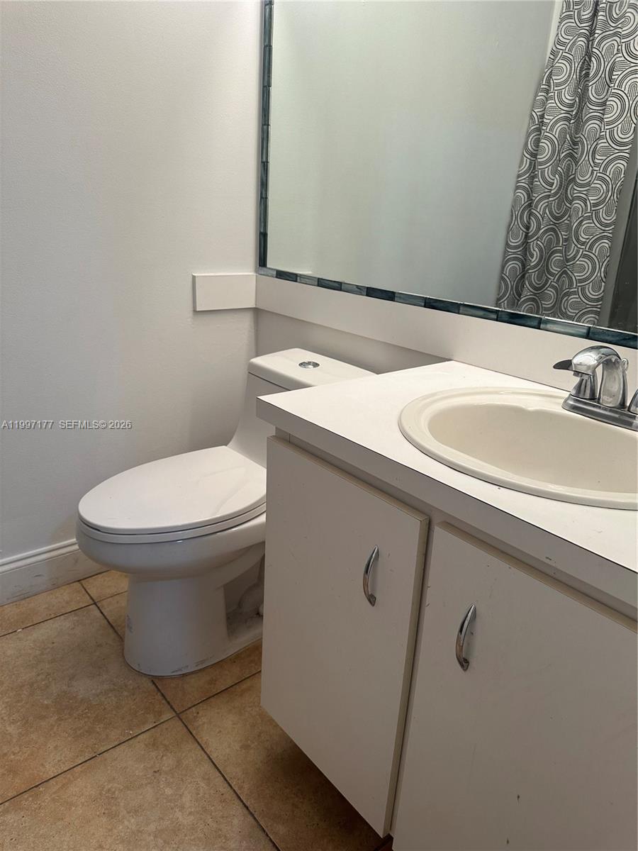 9724 Southwest 142nd Place Miami, FL 33186 - Photo 22 of 36 a bathroom with a sink and a toilet