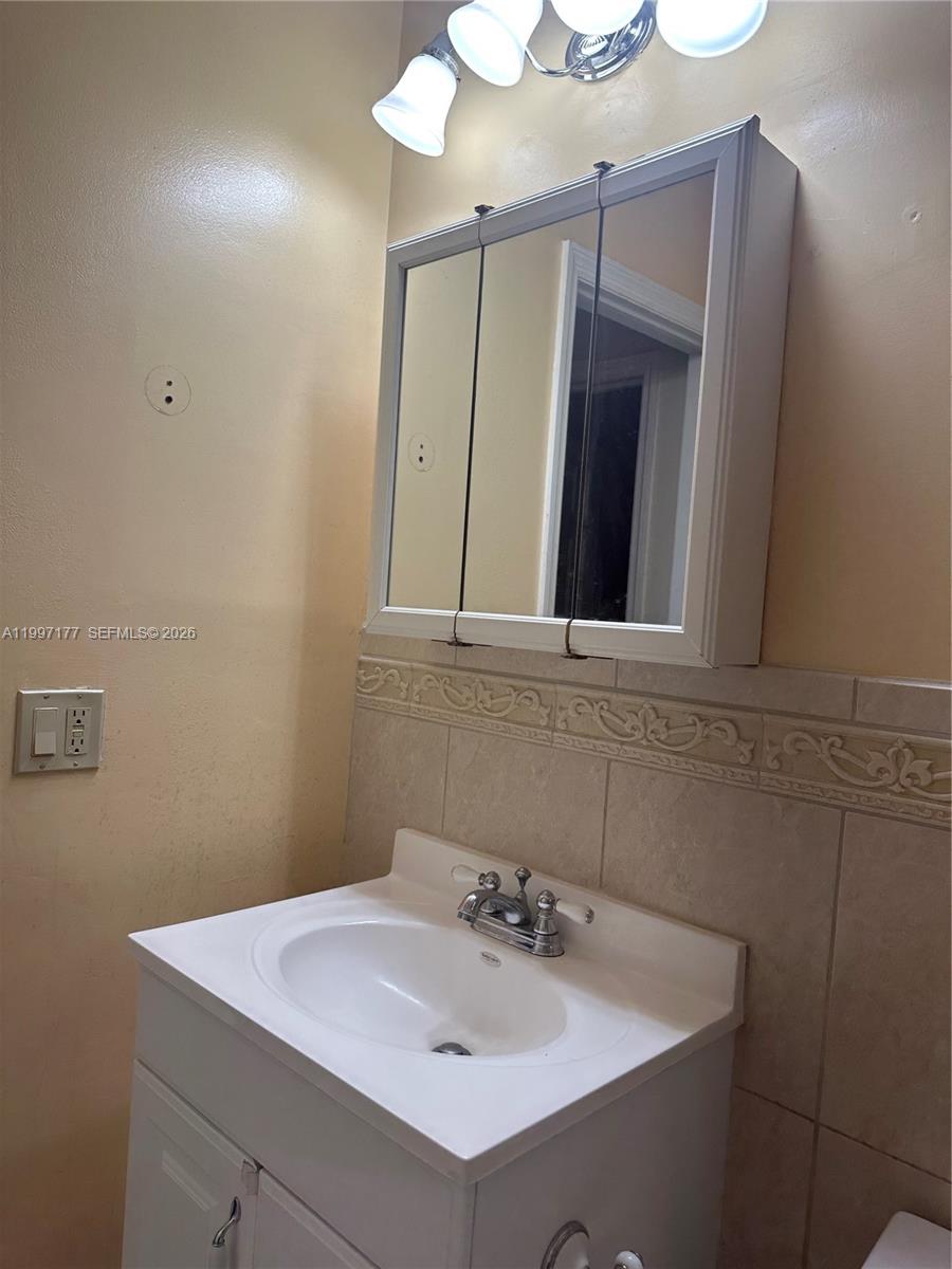 9724 Southwest 142nd Place Miami, FL 33186 - Photo 23 of 36 a bathroom with a sink vanity and mirror